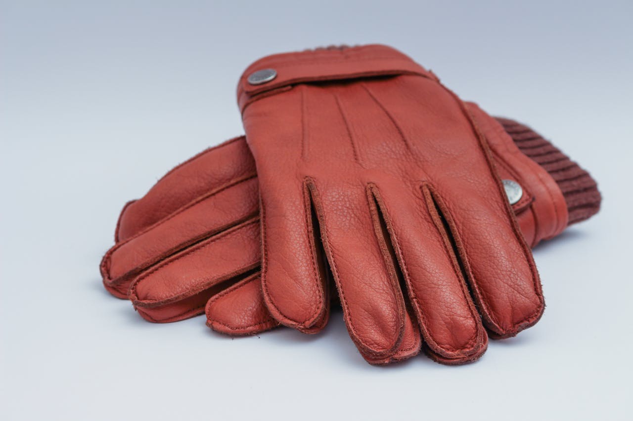 gallery-6 Close-up of brown leather gloves, perfect for winter fashion and warmth.